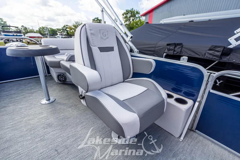 Slide: The Image of 2024 Godfrey Sweetwater 2286 SBX boat interior with comfortable seating and table. - 16