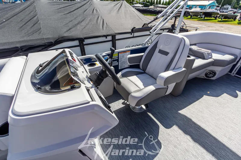 Slide: The Image of 2024 Godfrey Sweetwater 2286 SBX boat interior with captain's chair and helm. - 20