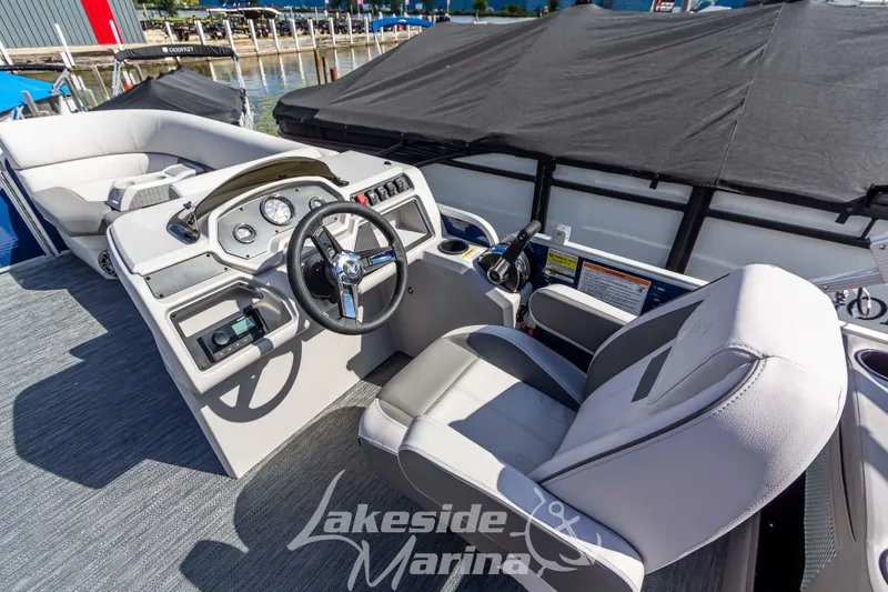 Slide: The Image of 2024 Godfrey Sweetwater 2286 SBX boat interior with steering wheel and seating at Lakeside Marina. - 21