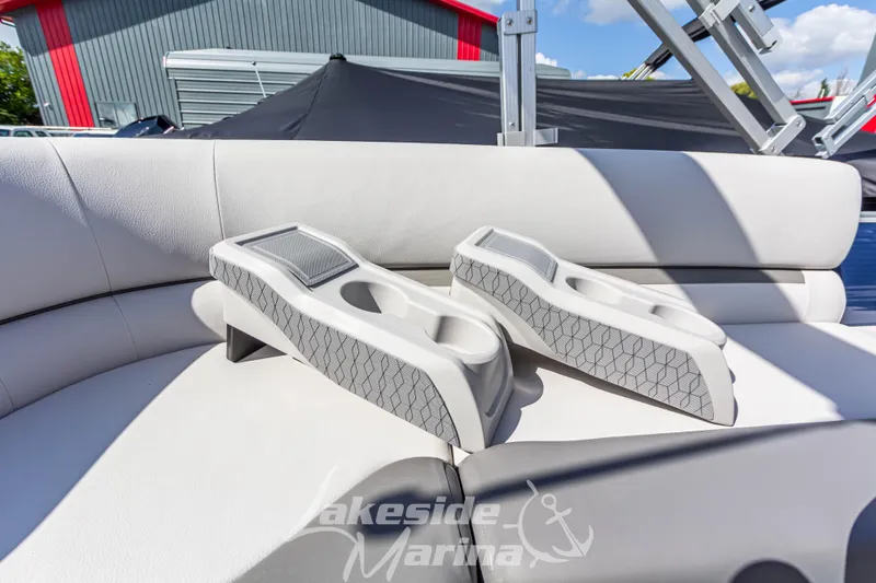 Slide: The Image of 2024 Godfrey Sweetwater 2286 SBX boat interior with cup holders on white seating. - 30