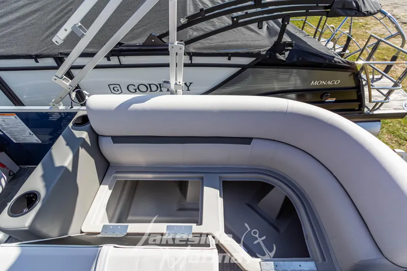 Slide: The Image of 2024 Godfrey Sweetwater 2286 SBX boat interior with storage compartments and seating. - 31