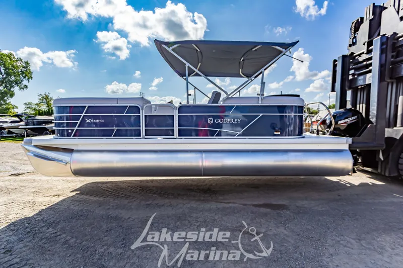 Slide: The Image of 2024 Godfrey Sweetwater 2286 SBX pontoon boat at Lakeside Marina under a clear sky. - 5