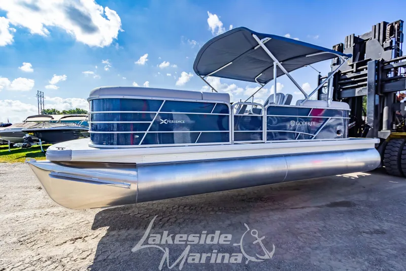 Slide: The Image of 2024 Godfrey Sweetwater 2286 SBX pontoon boat at Lakeside Marina under blue sky. - 6