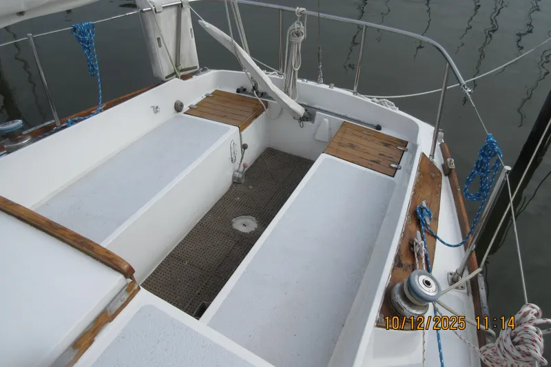 Slide: The Image of 1974 Tartan 30 sailboat cockpit with wooden accents and nautical ropes. - 5