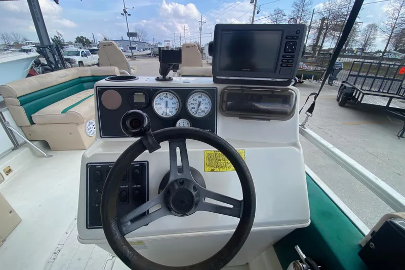 Slide: The Image of 1994 Hurricane FunDeck 226 boat dashboard with steering wheel and gauges. - 20