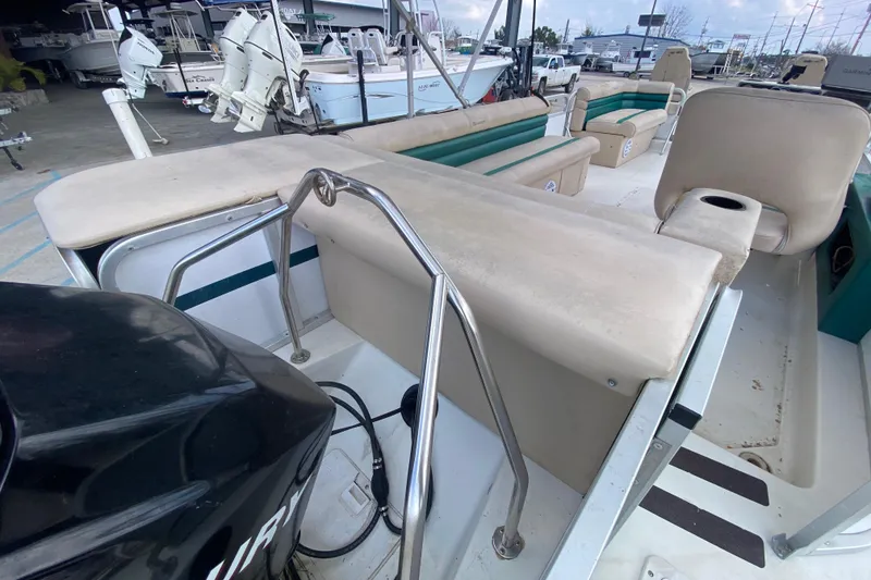 Slide: The Image of 1994 Hurricane FunDeck 226 boat interior with seating and engine view. - 23
