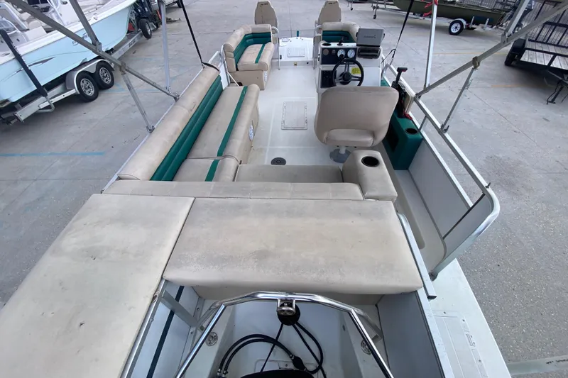 Slide: The Image of 1994 Hurricane FunDeck 226 boat interior with beige seating and steering console. - 24