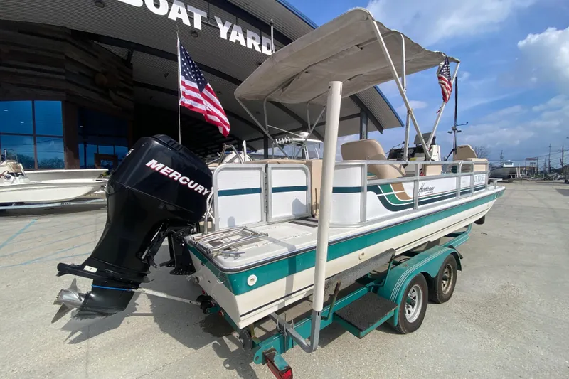 Slide: The Image of 1994 Hurricane FunDeck 226 boat with Mercury engine at a boat yard. - 4