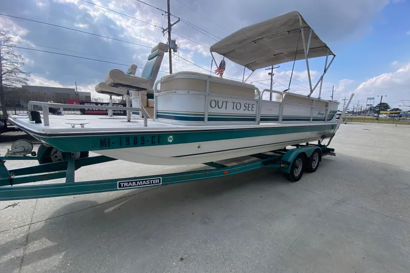 Slide: The Image of 1994 Hurricane FunDeck 226 boat on trailer, with canopy and "Out to See" text. - 8