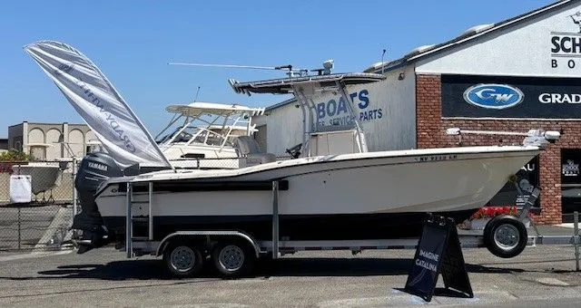 Slide: The Image of 2005 Grady-White Advance 257 boat on trailer outside a shop. - 33