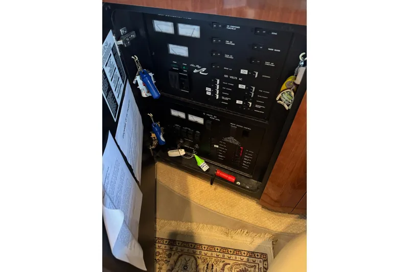 Slide: The Image of Electrical panel of a 2003 Sea Ray 480 Sedan Bridge yacht with keys and documents. - 11