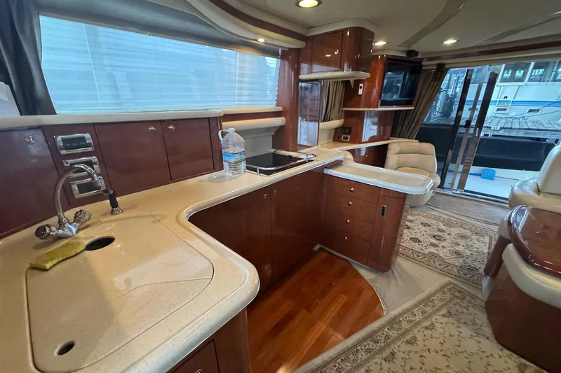 Slide: The Image of Luxurious 2003 Sea Ray 480 Sedan Bridge yacht interior with elegant kitchen and seating area. - 15