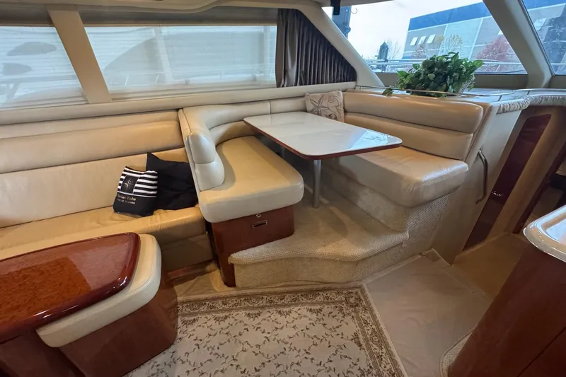 Slide: The Image of Luxurious interior of 2003 Sea Ray 480 Sedan Bridge yacht with elegant seating and table. - 16