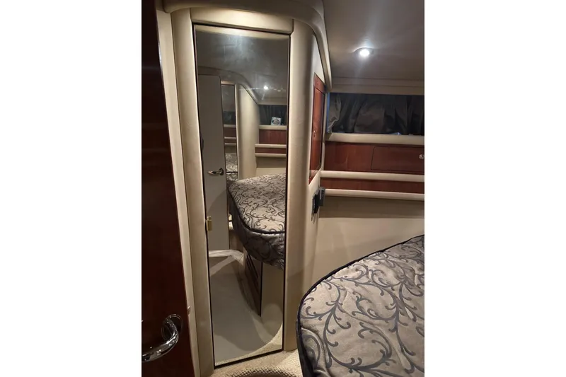 Slide: The Image of Interior of 2003 Sea Ray 480 Sedan Bridge, featuring elegant cabin design and mirrored door. - 19