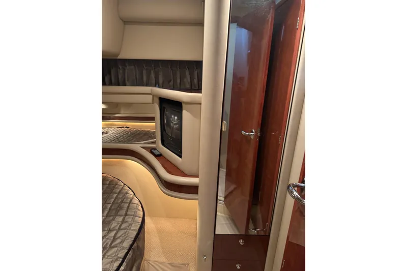 Slide: The Image of Interior of 2003 Sea Ray 480 Sedan Bridge yacht with TV and luxurious furnishings. - 21