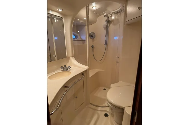 Slide: The Image of Luxurious bathroom in 2003 Sea Ray 480 Sedan Bridge yacht, featuring shower and vanity. - 22