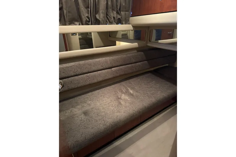 Slide: The Image of Interior seating of 2003 Sea Ray 480 Sedan Bridge yacht with cushioned bench. - 24