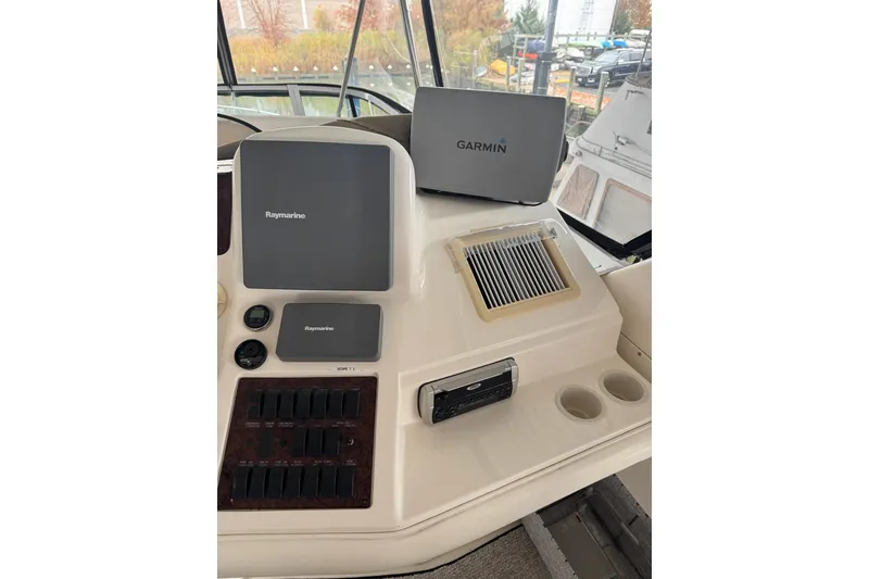 Slide: The Image of 2003 Sea Ray 480 Sedan Bridge helm with Raymarine and Garmin navigation systems. - 29