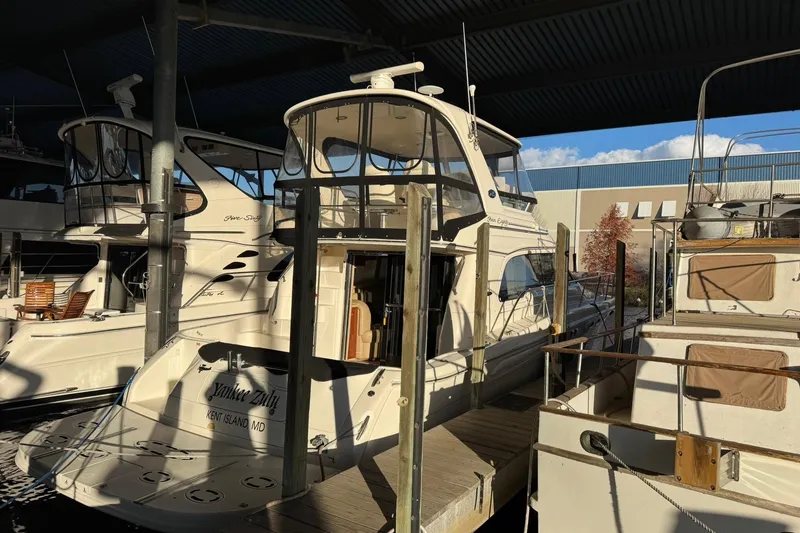 Slide: The Image of 2003 Sea Ray 480 Sedan Bridge yacht docked in a marina under a covered area. - 3