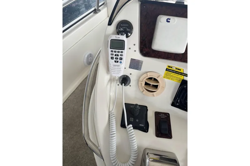 Slide: The Image of Control panel of a 2003 Sea Ray 480 Sedan Bridge with communication equipment. - 30