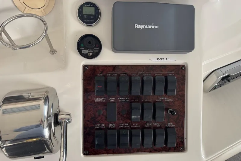 Slide: The Image of Control panel of a 2003 Sea Ray 480 Sedan Bridge with switches and Raymarine equipment. - 34