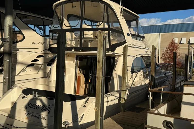 Slide: The Image of 2003 Sea Ray 480 Sedan Bridge yacht docked at marina, rear view. - 4