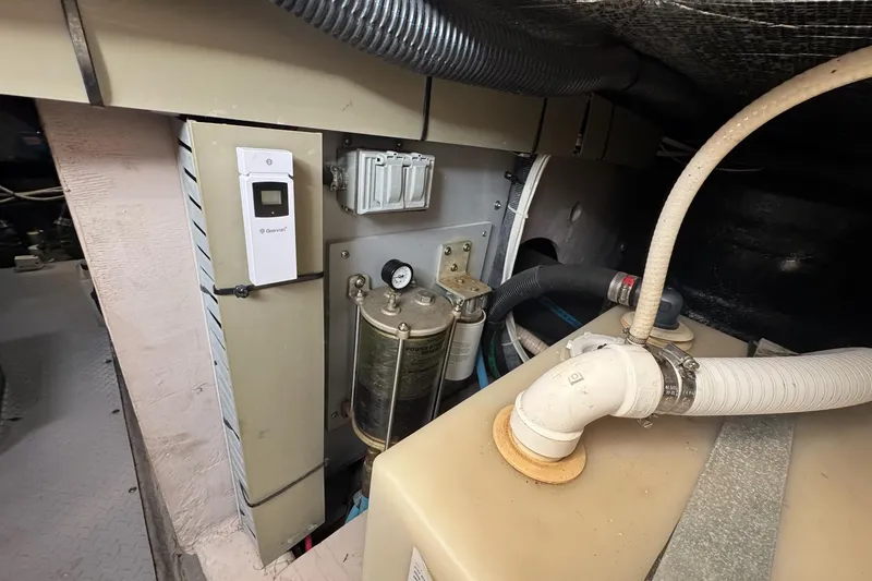 Slide: The Image of Engine room of 2003 Sea Ray 480 Sedan Bridge with mechanical components and piping. - 45