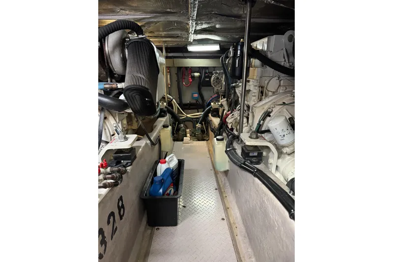 Slide: The Image of Engine room of 2003 Sea Ray 480 Sedan Bridge with visible components and equipment. - 46