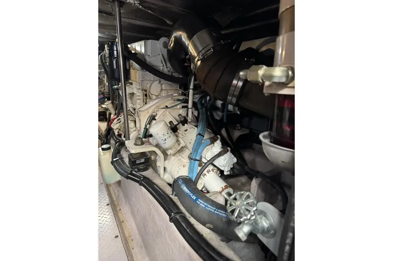 Slide: The Image of Engine room of 2003 Sea Ray 480 Sedan Bridge with visible components and hoses. - 47