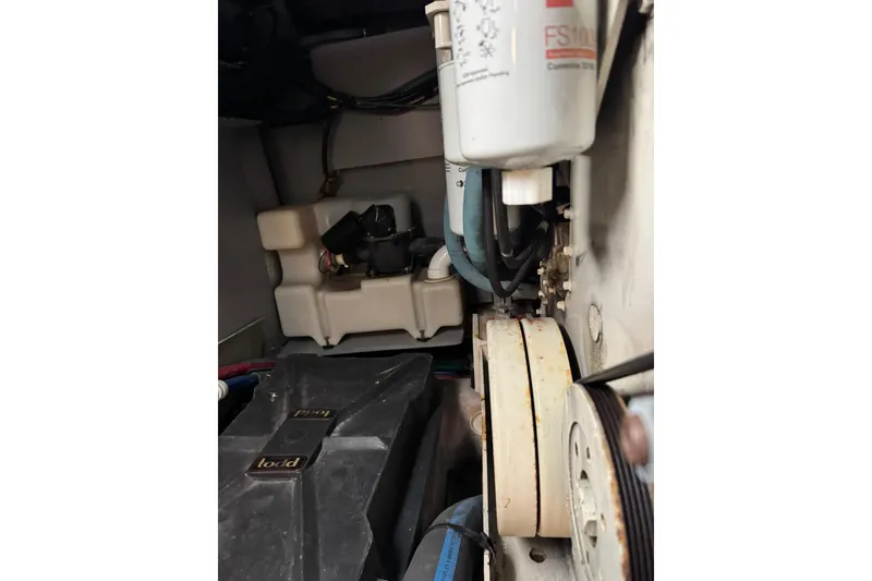 Slide: The Image of Engine compartment of a 2003 Sea Ray 480 Sedan Bridge, showing filters and belts. - 51