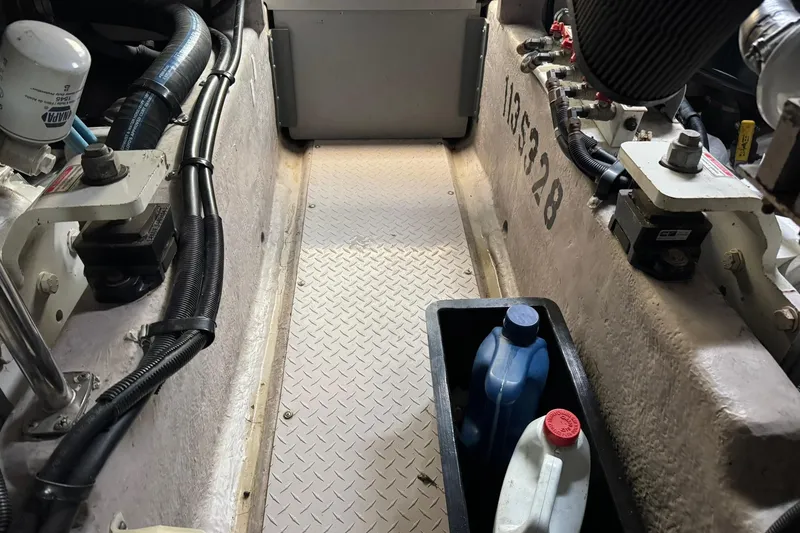 Slide: The Image of Engine room of a 2003 Sea Ray 480 Sedan Bridge with maintenance supplies. - 54
