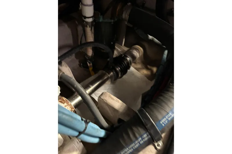 Slide: The Image of Engine compartment of 2003 Sea Ray 480 Sedan Bridge with visible hoses and components. - 55