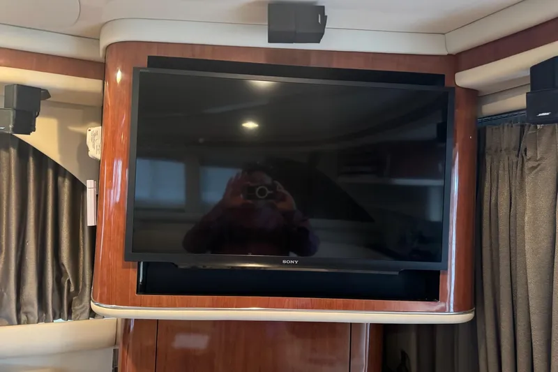 Slide: The Image of Sony TV in 2003 Sea Ray 480 Sedan Bridge yacht interior with wood paneling. - 9