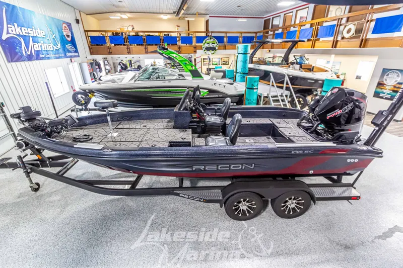 Slide: The Image of 2024 Recon 2185 SC boat in showroom. - 2