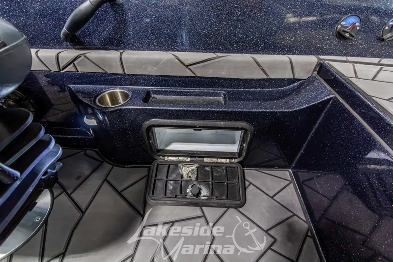Slide: The Image of Interior of 2024 Recon 2185 SC boat with storage and cup holder. - 34