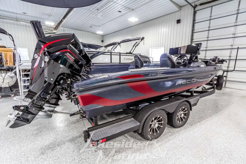 Slide: The Image of 2024 Recon 2185 SC boat in a garage, side view. - 7