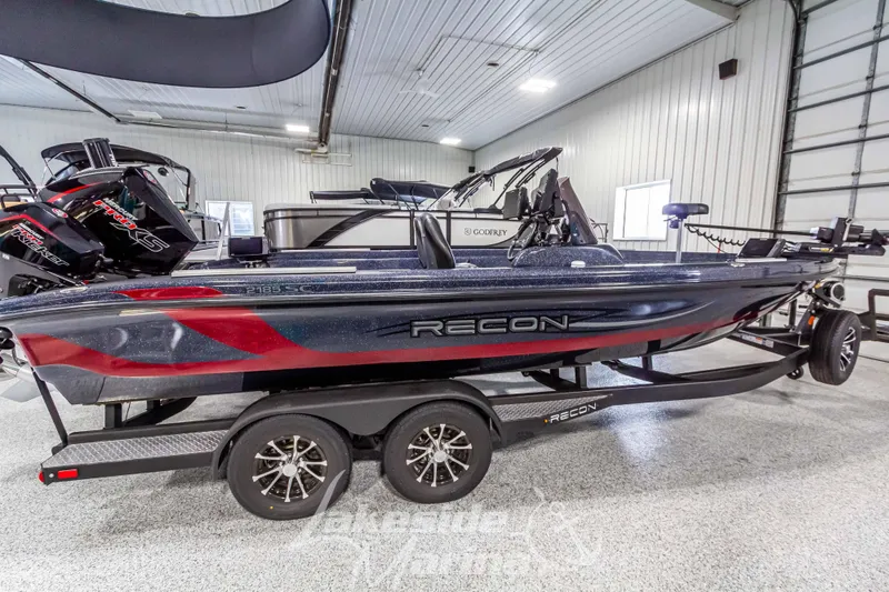 Slide: The Image of 2024 Recon 2185 SC boat in a garage on a trailer. - 8