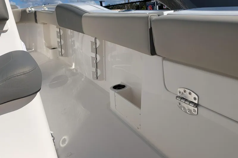 Slide: The Image of 2026 Key West 291 FS boat interior with cushioned seating and cup holder. - 10