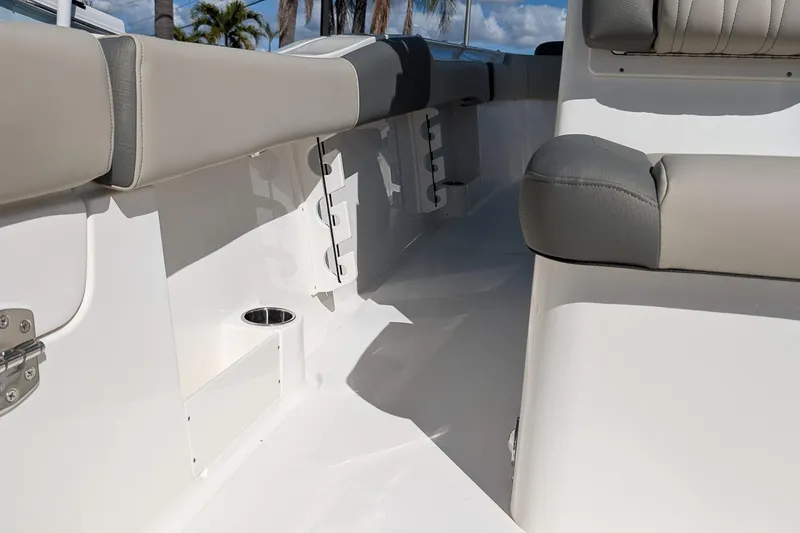 Slide: The Image of 2026 Key West 291 FS boat interior with cushioned seating and cup holder. - 11
