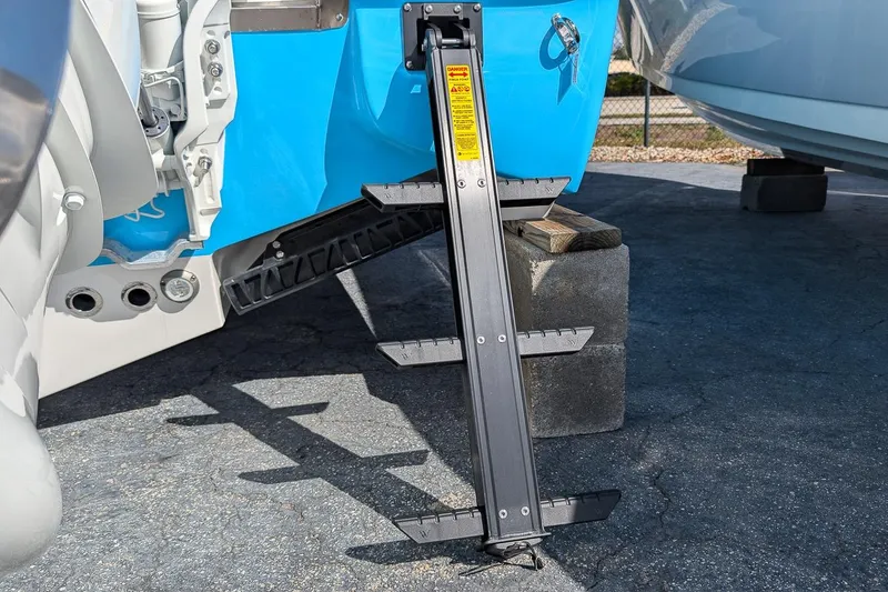 Slide: The Image of 2026 Key West 291 FS boat ladder on concrete blocks, blue hull detail. - 4
