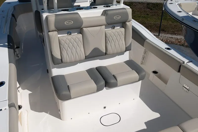 Slide: The Image of 2026 Key West 291 FS boat seating area with gray and beige upholstery. - 8