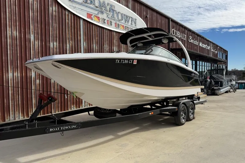 Slide: The Image of 2014 Four Winns SL242 boat on trailer outside Boat Town Inc. showroom. - 1
