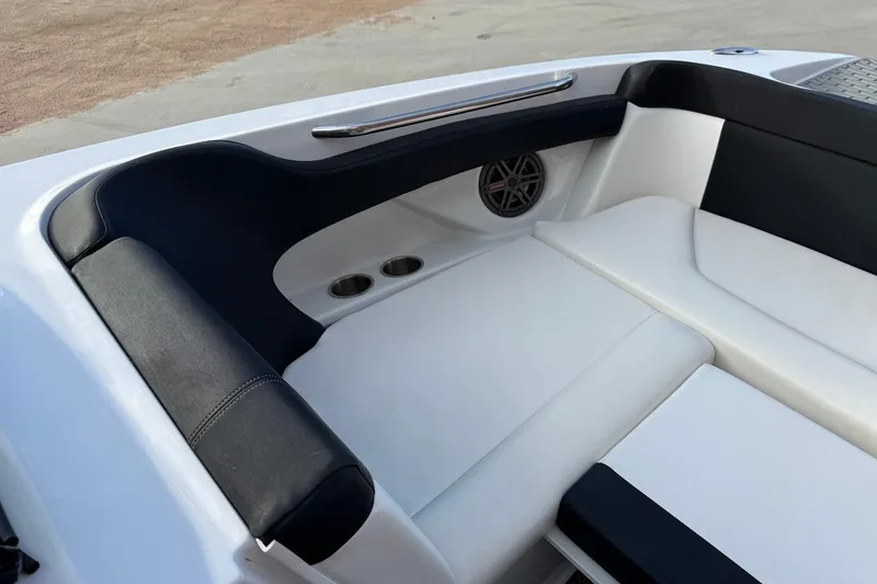 Slide: The Image of Interior seating of 2014 Four Winns SL242 boat with cup holders and speaker. - 15