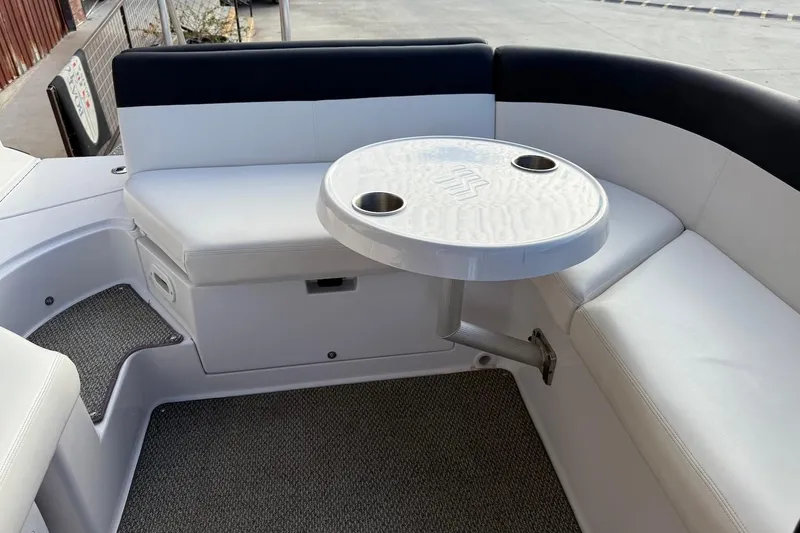 Slide: The Image of 2014 Four Winns SL242 boat interior with white seating and round table. - 19