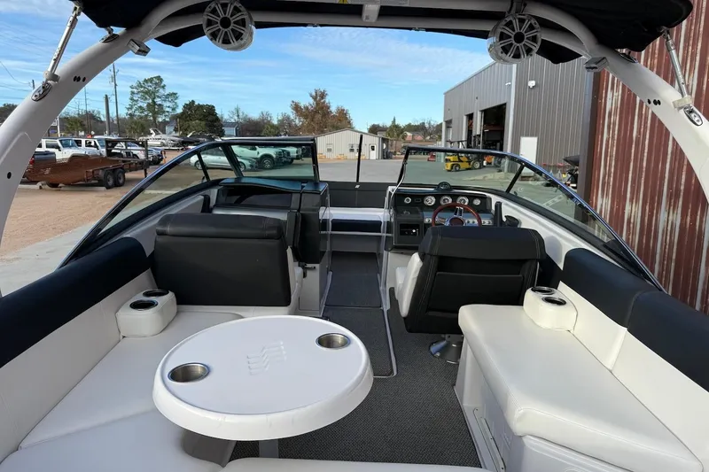 Slide: The Image of 2014 Four Winns SL242 boat interior with seating, table, and dashboard. - 5