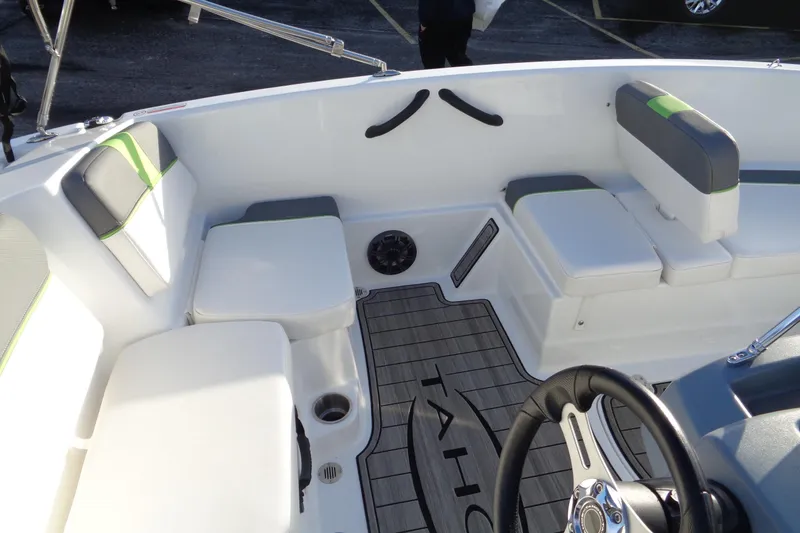 Slide: The Image of 2023 Tahoe T16 boat interior with cushioned seating and steering wheel. - 11