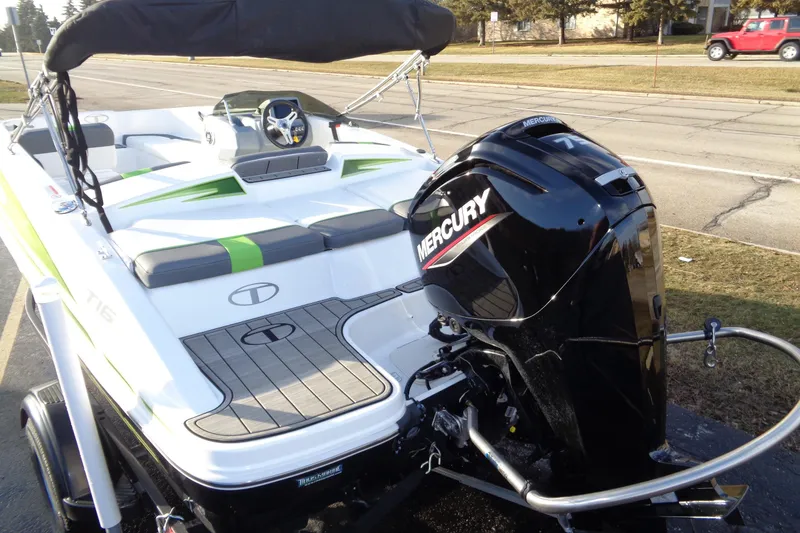 Slide: The Image of 2023 Tahoe T16 boat with Mercury engine, parked on a roadside. - 12