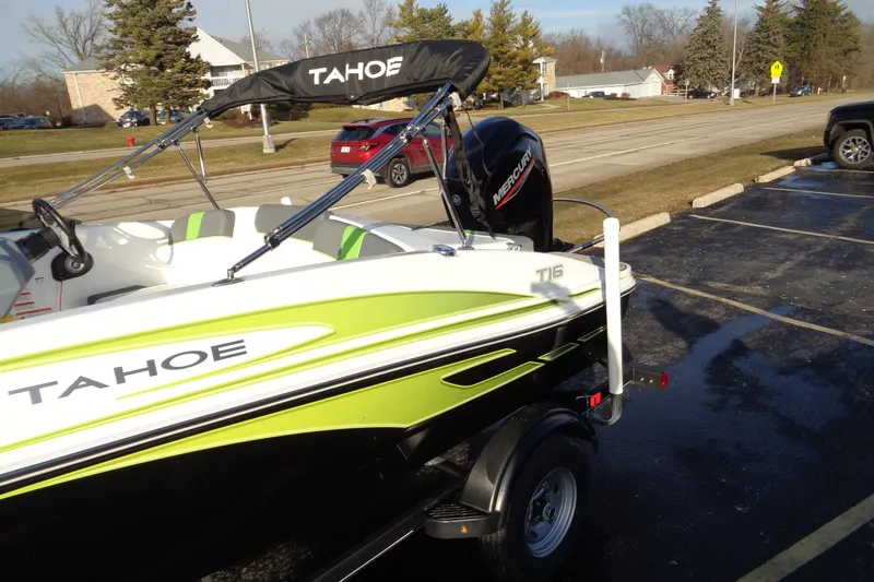 Slide: The Image of 2023 Tahoe T16 boat with Mercury engine in a parking lot. - 14