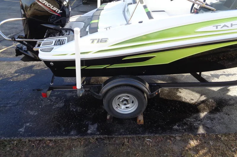 Slide: The Image of 2023 Tahoe T16 boat on trailer with green and black design, featuring a Mercury engine. - 4