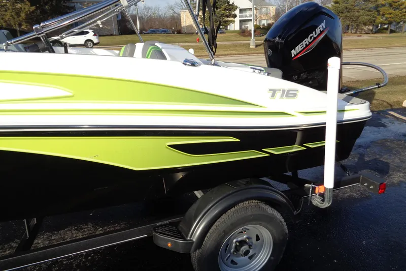 Slide: The Image of 2023 Tahoe T16 boat with green accents on a trailer, featuring a Mercury outboard motor. - 5